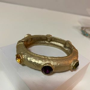 goldtone statement bangle with 6 beautiful rhinestones. It opens